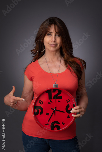 woman holding a red clock
