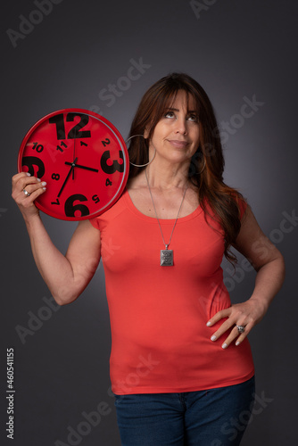 woman holding a red clock