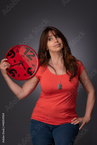 woman holding a clock