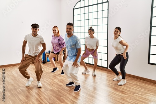 Group of young dancer smiling happy dancing choreography at dance academy.