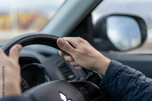 view of mans hands driving a car