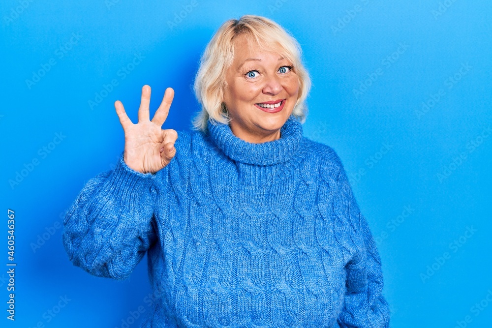 Middle age blonde woman wearing casual clothes showing and pointing up with fingers number three while smiling confident and happy. Middle age blonde woman wearing casual clothes showing and pointing up with fingers number three while smiling confident and happy.