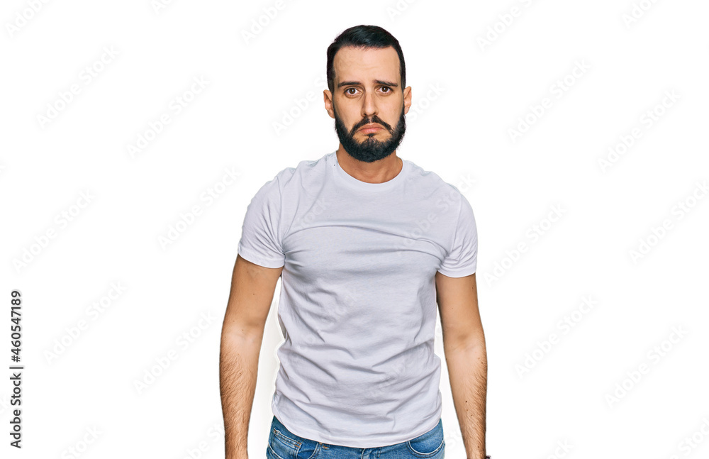Young man with beard wearing casual white t shirt depressed and worry for distress, crying angry and afraid. sad expression. Young man with beard wearing casual white t shirt depressed and worry for distress, crying angry and afraid. sad expression.