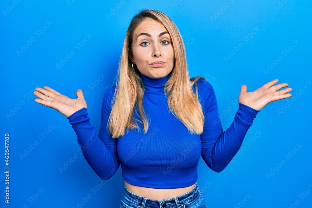 Young caucasian woman wearing casual clothes clueless and confused with open arms, no idea and doubtful face. Young caucasian woman wearing casual clothes clueless and confused with open arms, no idea and doubtful face.
