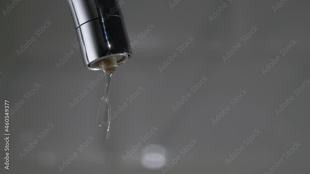 Water drips from the tap. Mixer in the kitchen. Pure clear drinking water. Water drips from the tap. Mixer in the kitchen. Pure clear drinking water.