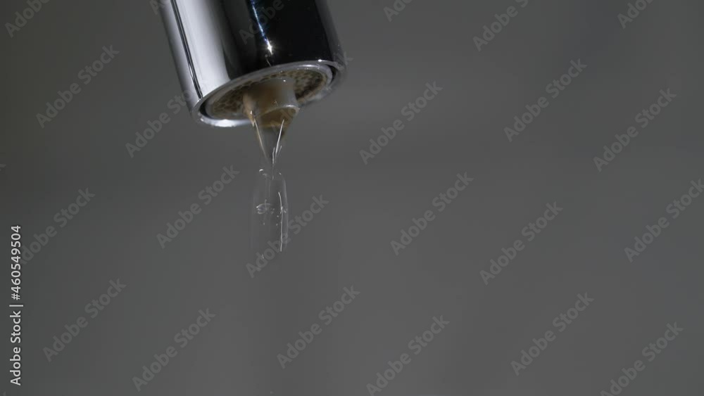 Water drips from the tap. Mixer in the kitchen. Pure clear drinking water. Water drips from the tap. Mixer in the kitchen. Pure clear drinking water.