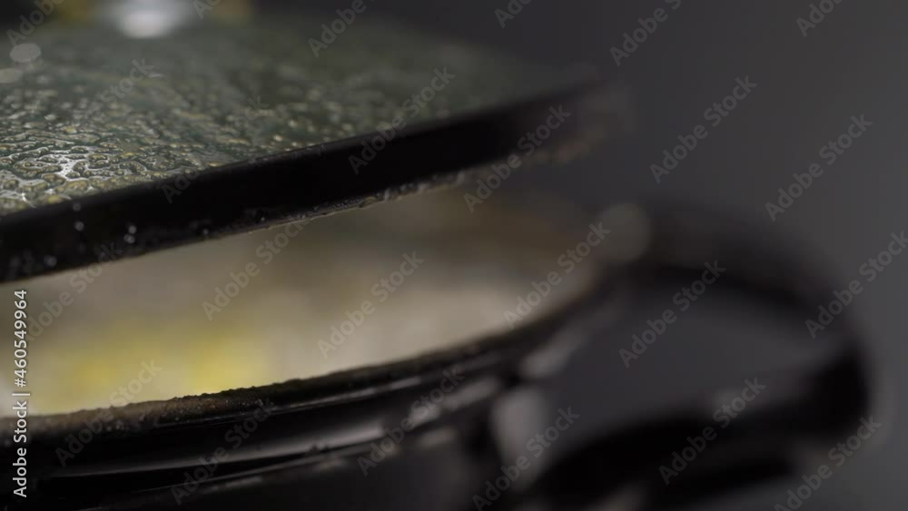 A saucepan on the stove in the kitchen. Boiling bubbling water while cooking. A saucepan on the stove in the kitchen. Boiling bubbling water while cooking.