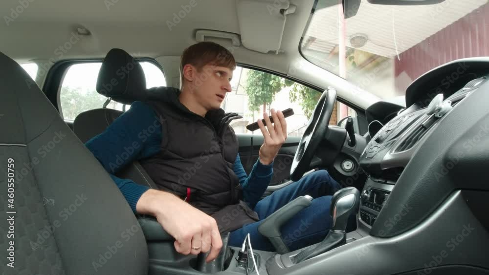 Man calls on speakerphone sitting in the car Man calls on speakerphone sitting in the car