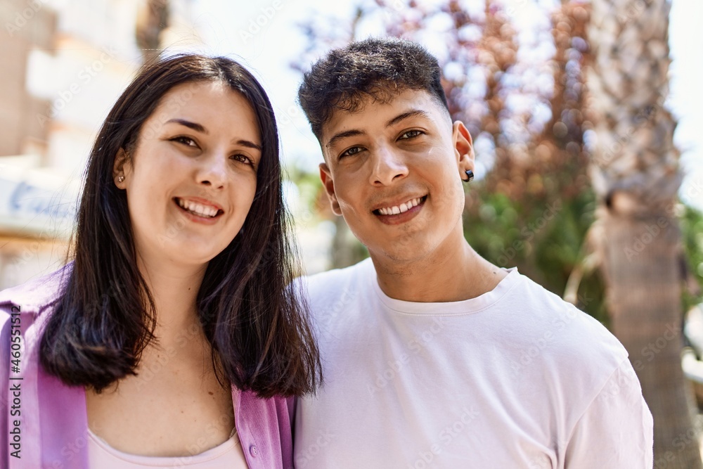 Young hispanic couple of boyfriend and girlfriend together outdoors on a sunny day Young hispanic couple of boyfriend and girlfriend together outdoors on a sunny day