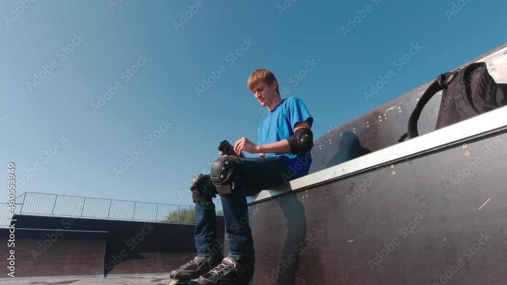 Man in protection in a skatepark on roller skates Man in protection in a skatepark on roller skates