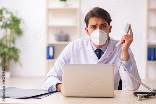 Young male doctor in telemedicine concept during pandemic