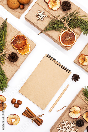 Wallpaper Mural 
Gift boxes wrapped reusable craft paper, decorated dried fruits, pine cones, fir branches and blank spiral notebook. Zero wast Christmas composition. Trendy branding mock up. New year gifts mockup. Torontodigital.ca