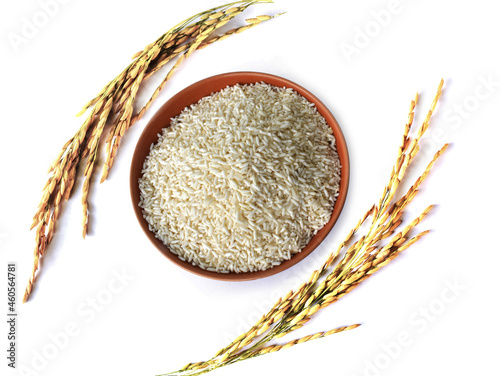top view of white rice in a bowl and ears of rice isolated on white background