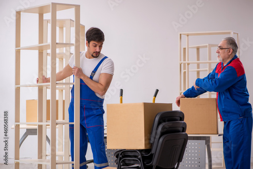 Two male professional movers doing home relocation