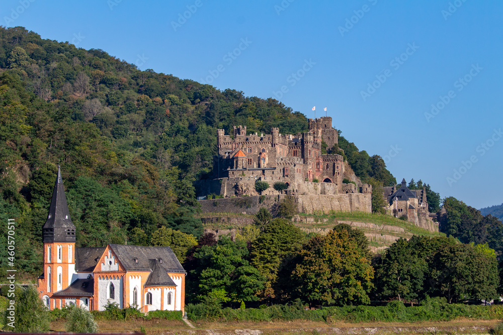 Reichenstein Castle on the upper middle Rhine River near Trechtingshausen, Germany, with view of St. Clement’s Chapel in the foreground