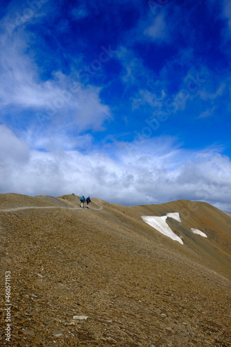 Rockies mountains hiking on a ridge, blue sky, outdoor adventure, people on a ridge