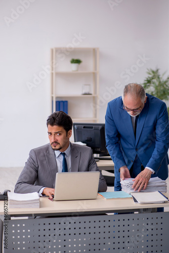 Two male colleagues working in the office © Elnur