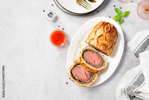 Beef Wellington - beef tenderloin festive dish. English cuisine. Light gray stone background. top view photo