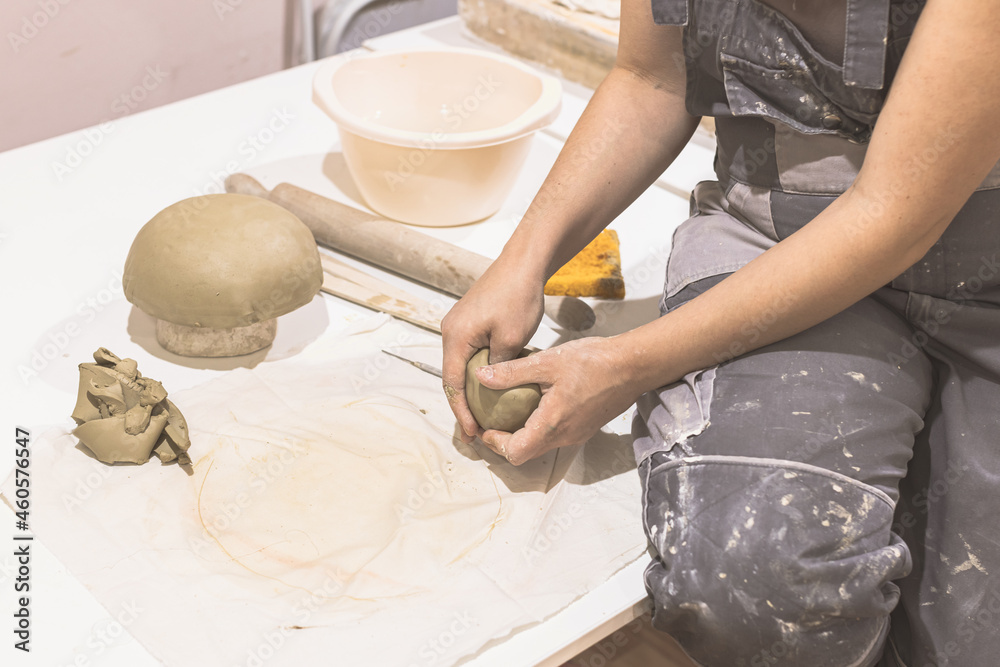 Female Pottery Making Ceramics On Table At Art Studio. Creative hobby
