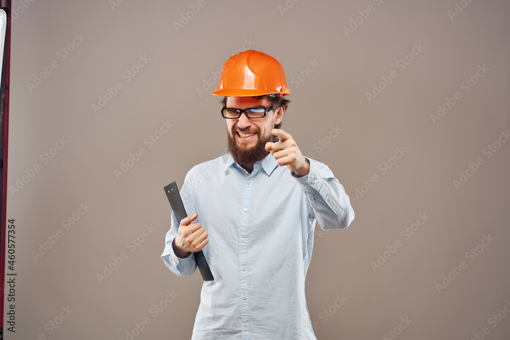 bearded man orange helmet on the head Studio hand gesture bearded man orange helmet on the head Studio hand gesture