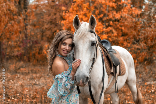Young woman in the park with a horse