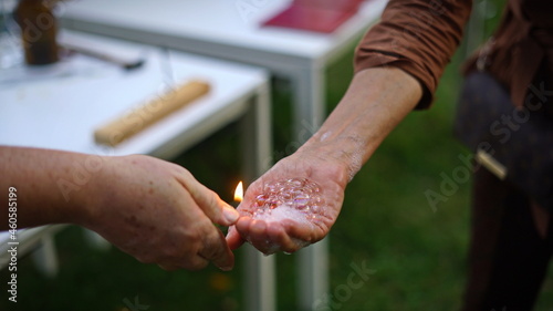Magic of chemistry flaming hand, lighting and holding a small fire in your hand with butane-filled soap bubbles