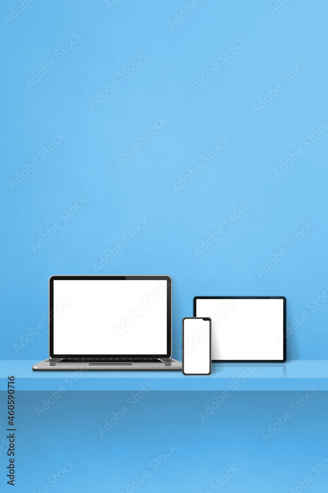 Laptop, mobile phone and digital tablet pc on blue wall shelf. Vertical background Laptop, mobile phone and digital tablet pc on blue wall shelf. Vertical background