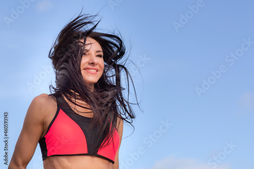 A woman runs in the morning workout, hair fluttering in the wind