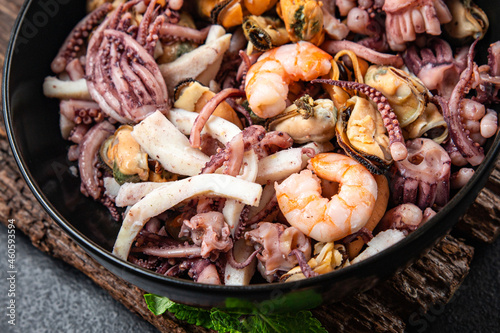 seafood mix shrimp, squid, mussel, rapan, octopus fresh portion ready to eat meal snack on the table copy space food background rustic. top view keto or paleo diet vegetarian food pescetarian diet © Alesia Berlezova