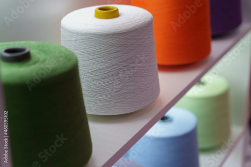 large group of bobbin thread cones on the shelf