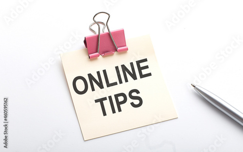 ONLINE TIPS text on sticker with pen on the white background