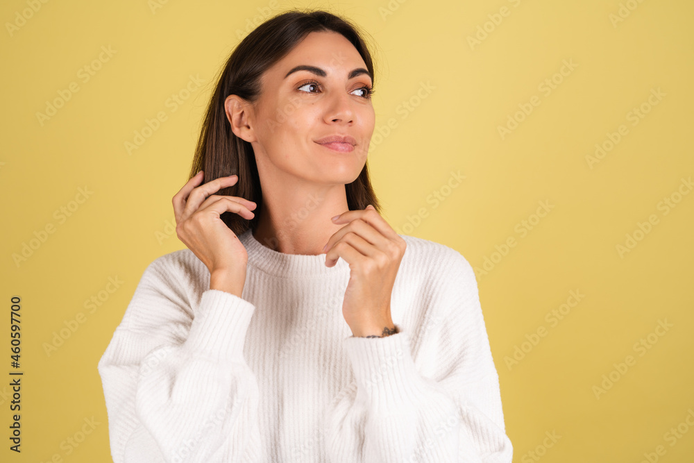 Young woman in white warm sweater happy smiling cheerful look aside cute positive Young woman in white warm sweater happy smiling cheerful look aside cute positive