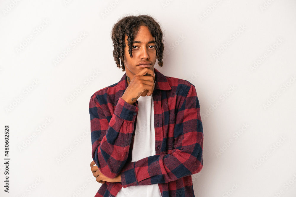 Young african american man isolated on white background thinking and looking up, being reflective, contemplating, having a fantasy. Young african american man isolated on white background thinking and looking up, being reflective, contemplating, having a fantasy.