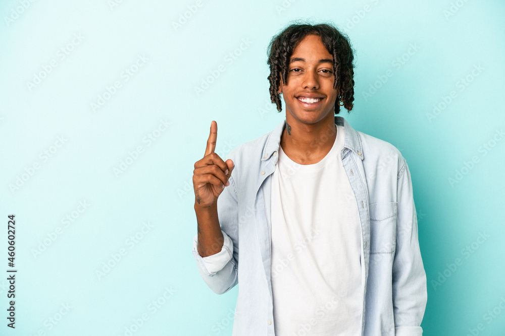 Young african american man isolated on blue background showing number one with finger. Young african american man isolated on blue background showing number one with finger.