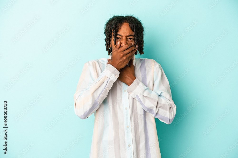 Young african american man isolated on blue background suffers pain in throat due a virus or infection.