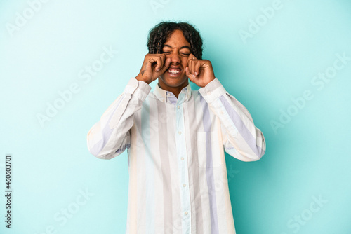 Young african american man isolated on blue background whining and crying disconsolately.