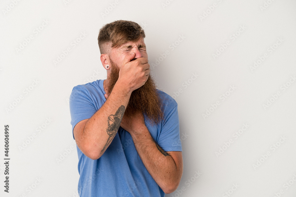 Young caucasian ginger man with long beard isolated on white background suffers pain in throat due a virus or infection. Young caucasian ginger man with long beard isolated on white background suffers pain in throat due a virus or infection.