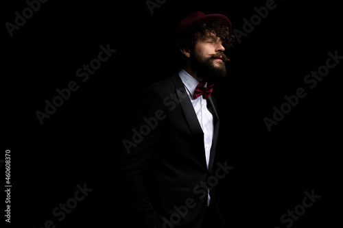 handsome businessman living the moment and wearing a burgundy hat
