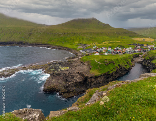 Gjógv (gorge, geo), Eysturoy island, Faroe Islands. Set in a spectacular natural setting with a long ocean gorge and towering cliffs with enormous bird colonies