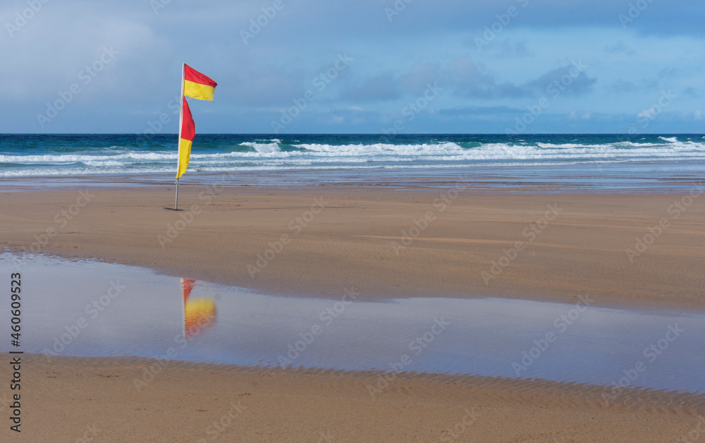 Yellow and red beach safety flag used by the RNLI to denote the safe areas to swim and surf