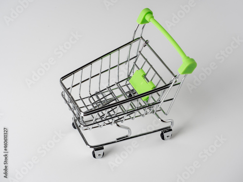 Close-up of green shopping carts on a white background. Sales concept. Cart, products.