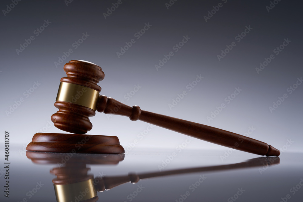 close up of gavel hammer on gray background close up of gavel hammer on gray background