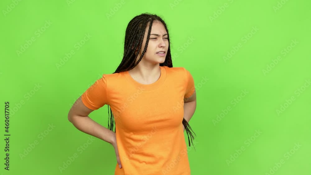 Teenager girl with braids suffering from pain in shoulder for having made an effort over isolated background Teenager girl with braids suffering from pain in shoulder for having made an effort over isolated background