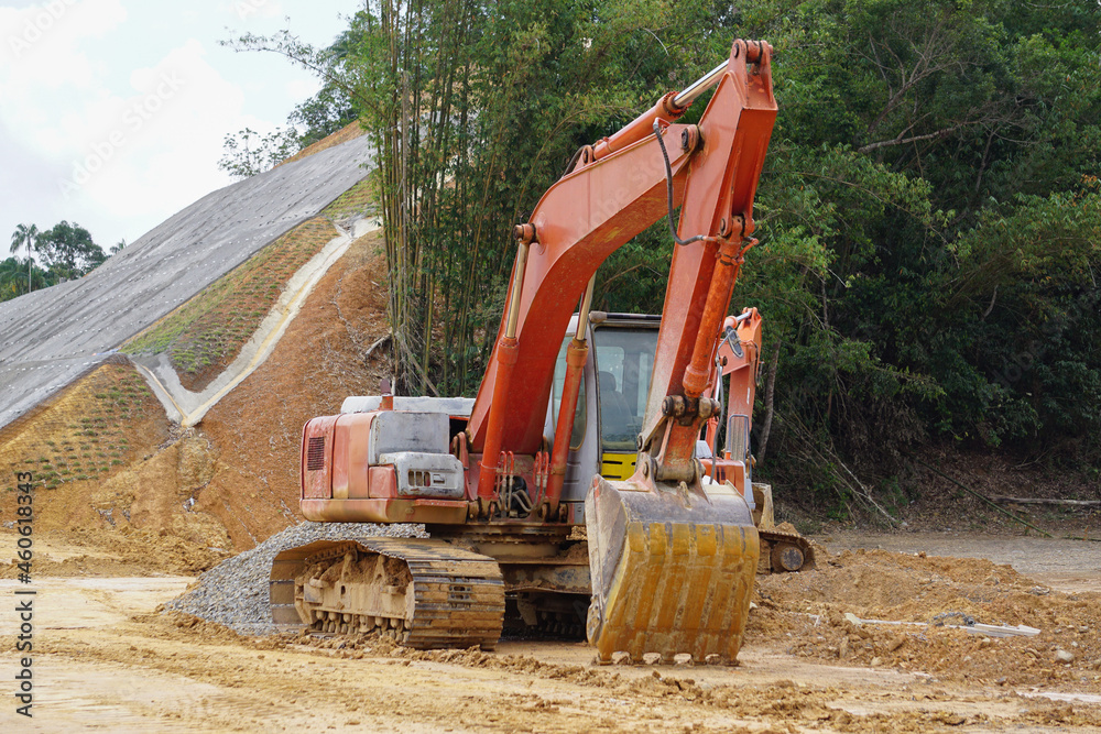 Heavy construction equipment excavator at road construction site. Heavy construction equipment excavator at road construction site.