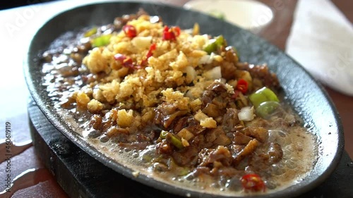 hot and spicy sizzling pork sisig, famous snack or appetizer among local Filipinos