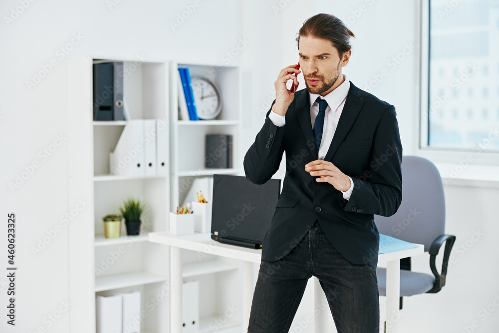 man in a suit in the office with documents lifestyle man in a suit in the office with documents lifestyle