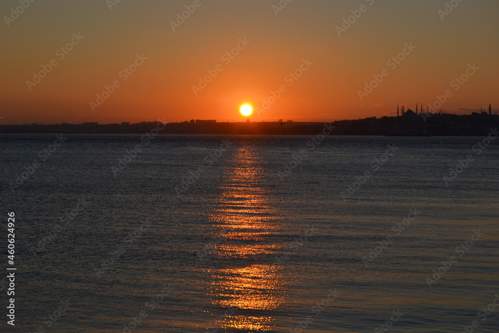 Dark sunset with orange sun,colorful sky above sea and horizon. Bosphorus coast,Istanbul.