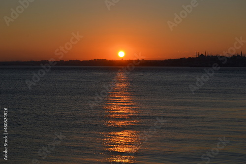Dark sunset with orange sun,colorful sky above sea and horizon. Bosphorus coast,Istanbul.