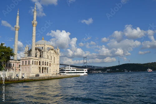 Ortakoy mosque under blue sky with clouds on Bosphorus coast during summer time in Istanbul.