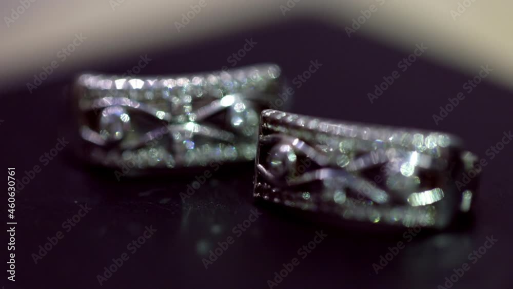 Shifting the focus from one silver cufflink to another and the play of light glare. Macro Shifting the focus from one silver cufflink to another and the play of light glare. Macro
